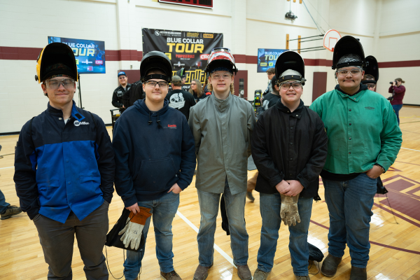  Five high schoolers pose with welding masks